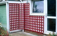 Step by step make-over - whitewashed wall with wooden trellis painted red