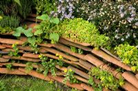 Low retaining wall made from roof tiles 