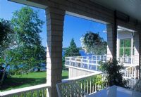 Shot of garden and sea from verandah porch of house - North East Harbor, Maine USA