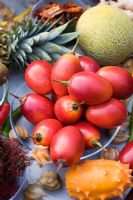 Tropical fruit including tamarillo - tree tomato, kiwano - horned melon , pineapple and melon