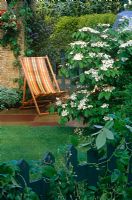 Deckchair on paved area in small front garden