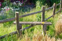 A stile over a fence in The Miller's Garden at the RHS Hampton Court FS
