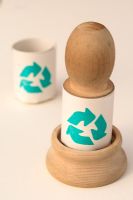 Wooden paper potter tool and a biodegradable newspaper pot with a recycling symbol