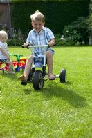 Children on toy bicycles