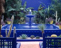 Courtyard with blue fountain surrounded by cacti in the Moroccan style Yves St. Laurent garden - Chelsea 1997