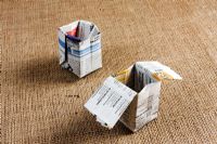 Making paper pots - finished boxes - flaps can be folded inside, but when the box is filled with compost they will stay flat if left out