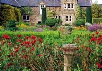 Red bed in the flower garden including Monarda didyma, Knautia macedonica, Sangiusorba officinalis and alliums - Herterton House, nr Cambo, Morpeth, Northumberland