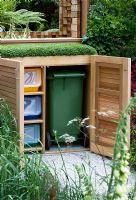 Wooden dustbin and recycling cupboard in The Children's Society Garden, Designed by Mark Gregory, Sponsor - The Co-operative, Chelsea Flower Show 2008