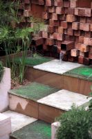 The Pemberton Greenish Recess Garden with with cascading water feature and Cyperus papyrus - RHS Chelsea Flower Show 2008