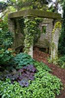 Lamium, Heuchera and Geranium as ground cover in the shade by a stone arbour - Dewstow Hidden Gardens and Grottos