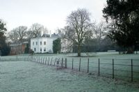 Frosty winter garden with large house set in parkland - Spencers, Great Yeldham, Essex