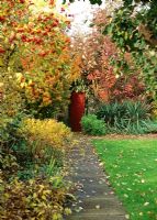 Walled garden with path view showing Autumn mixed border - Saling Hall