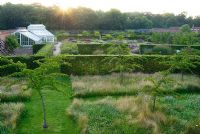 A view from the Mount at sunrise overlooking the walled garden at Scampston Hall designed by Piet Oudolf