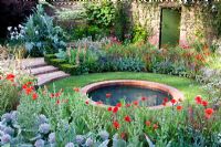 Circular brick lined pond surrounded by mixed border - The Largest Room in the House Garden - Chelsea Flower Show 2008, Sponsors - GMI Property Company, The Royal British Legion, Toc H 
