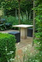 Modern seating and table in quiet corner of shaded garden, The Reflective Garden Sponsor - Ruffer LLP - RHS Chelsea Flower Show 2008