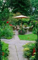 Intersecting pathway across lawn to dining area with parasol - Toronto, Canada