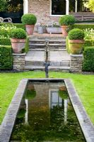 Rill leading from terrace to pond in lawn