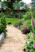 Reclaimed brick path laid in basketweave pattern in garden designers private garden
