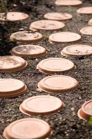 Terracotta saucers used as stepping stones in children's garden - Maja's Garden, Sofiero, Sweden
