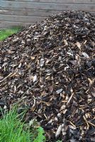 Heap of wood chippings ready for use as mulch or for pathways through the garden