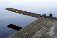 Wooden jetty and diving board on lake