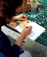 Woman writing in gardening journal
