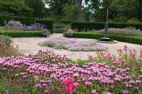 Flower borders with Monarda flowers at Saville Gardens, Surrey
