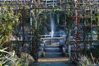 Winter gardens with water fountain and pollarded shrubs - Abbey House Gardens, Malmesbury, Wiltshire