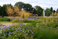 Mixed perennials and ornamental grasses including Geranium, Phlomis and Stipa gigantea in The Italian Garden at Trentham, designed by Tom Stuart-Smith