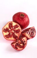 Punica granatum - Pomegranate fruit sliced and whole
