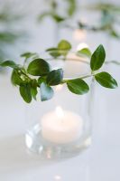 Candle holder decorated with Vinca minor foliage