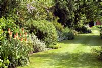 Deep shrub border and well maintained lawn, Woodwards NGS, Coddenham, Suffolk 