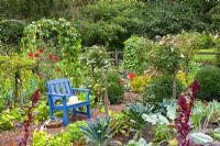 Seating area in Potager - Planting includes Brassica oleracea 'Nero Di Toscana',   Phaseolus 'Neckargold', Phaseolus 'Blauhilde', Tropaelum and Amaranthus