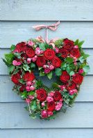 Valentine's wreath made from pink and red roses with ivy