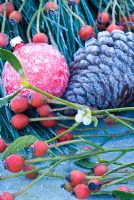 Frosted mistletoe, rosehips, pine cone and red bauble