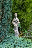 Statue of Pan surrounded by conifers at Cascades Gardens, Derbyshire NGS 