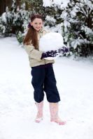 Girl building snowman