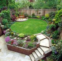 Suburban garden with raised lawn and flowerbeds 