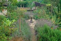 Central York stone birdbath in front garden with lavender either side of pathway - Saltford Farm, Bath, UK