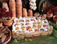 Stored apples in a wooden tray - Fruit is individually wrapped in paper to avoid spoiling