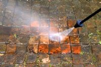 Cleaning patio bricks with pressure washer