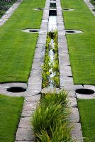 Water rill in middle of lawn with marginal plants - Hestercombe Gardens, Somerset