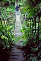 A rope bridge spans a deep ravine - Les Jardins de Quatre-Vents, Quebec