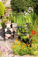 Black wrought iron table and chairs on a garden patio