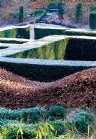 View over the Yew Hedging from within the Grasses Parterre, Beech 'wavy' hedge in foreground and part of the Wild Garden beyond - Veddw House Garden, February 