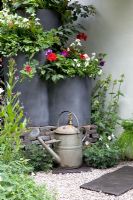 Watering can and water butt planters - Entente Cordiale, A Touch of France Garden, sponsored by Bonne Maman, Clarke and Spears Clarke and Spears International Ltd, The English Garden Magazine - Silver-Gilt Flora medal winner for Courtyard Garden at RHS Chelsea Flower Show 2009
