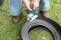 Making a tyre garden - Use a jigsaw with a coarse blade to cut out the rim