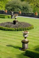 Balustrading, urns, geometric box-edged beds and lawn in the formal terraced garden at Rydal Hall, Cumbria
