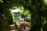 Mediterranean style rustic outdoor dining area in garden setting