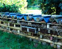 Insect hotel made from old pallets, tiles, twigs and logs